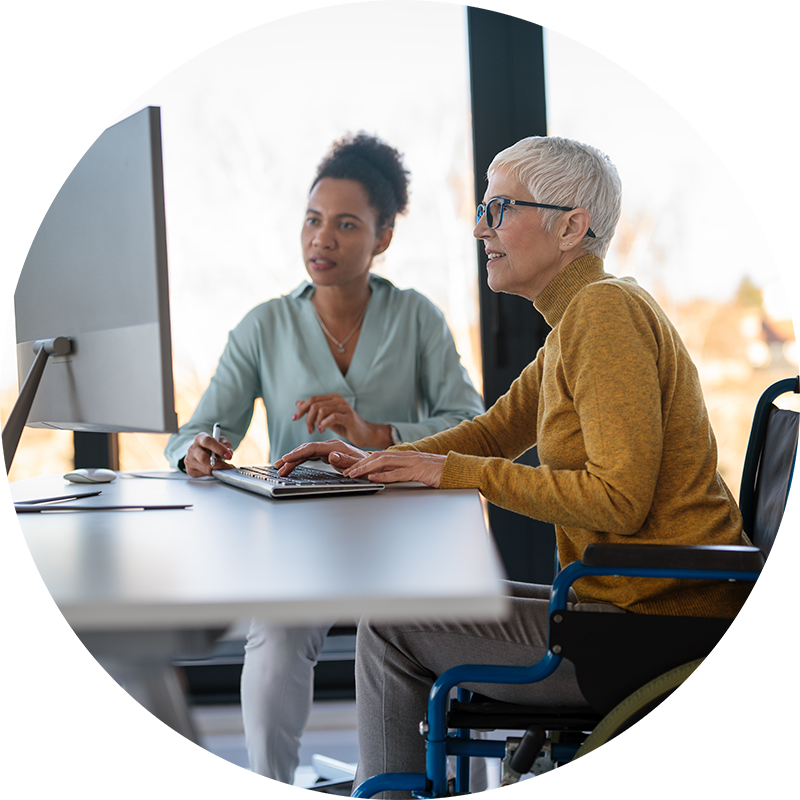 disabled woman in wheelchair looking at computer